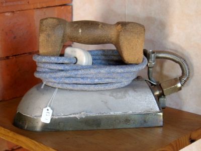 EI001
Electric Steam Iron with cork handle 'HOFFMAN No. 22931'. The steam for the iron was provided by an external generator through a hose attached to the iron
